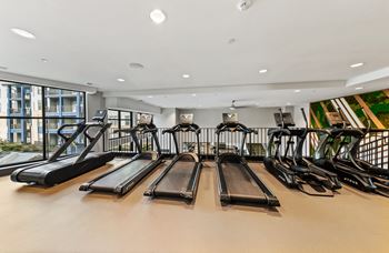 A gym with treadmills and exercise bikes.